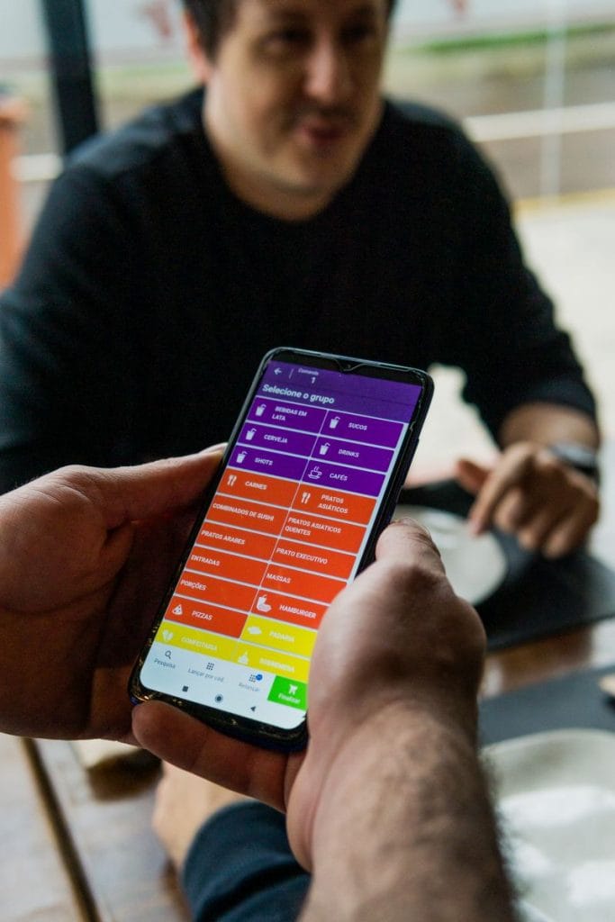 Garçom usando comanda eletrônica restaurante no celular